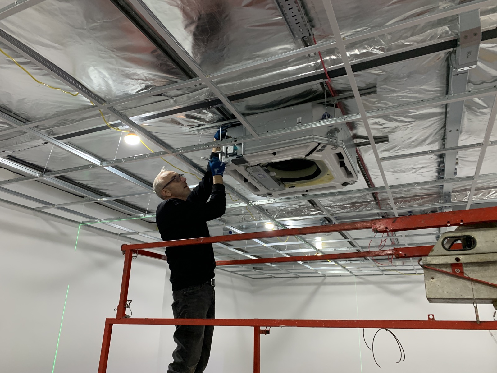 Our engineer installing a ceiling cassette air conditioning unit